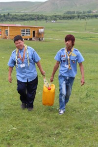 Scouts collecting water from the well situated behind the wooden mess hut.